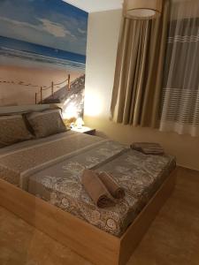 A bed or beds in a room at Apart Hotel Iglika