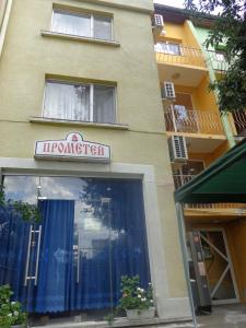 a store front of a building with a sign on it at Prometei in Burgas