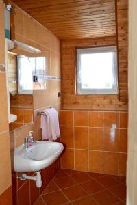 a bathroom with a sink and a window at Benedekné Háza in Gyenesdiás