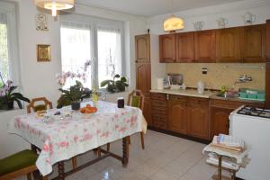 a kitchen with a table in the middle of it at Benedekné Háza in Gyenesdiás