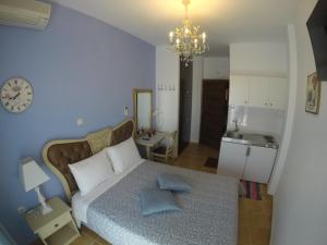 a bedroom with a bed with two pillows on it at Akrotiri Hotel in Neos Marmaras