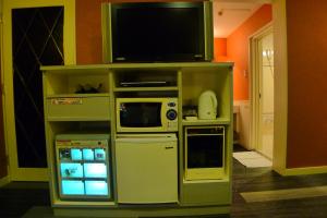 a entertainment center with a television and appliances at Hotel GOLF III Atsugi (Adult Only) in Atsugi
