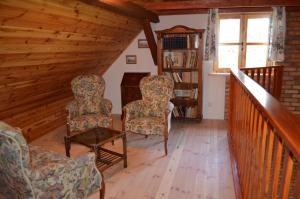 a living room with two chairs and a table at Wyspa Świerków in Lipusz