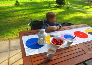 ワジにあるBabie Latoの果物を一皿に盛り付けたテーブルに座る少年