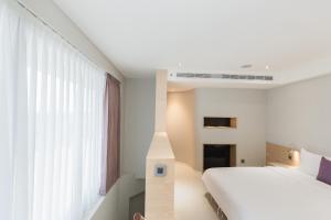 Postel nebo postele na pokoji v ubytování Ai Mei Homestay