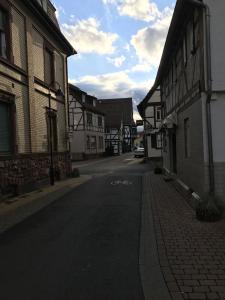 an empty street in a small town with buildings at Suite Edin in Maintal
