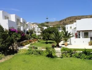 a view of a yard with white buildings at Vidalis Hotel in Kionia