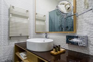 a bathroom with a white sink and a mirror at Aquaticum Debrecen Termal & Wellness Hotel in Debrecen