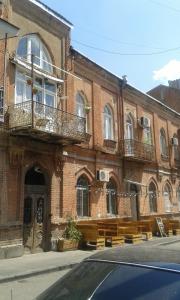 a brick building with benches in front of it at Art House in Tbilisi City