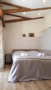 a bedroom with a bed with towels on it at Art House in Tbilisi City