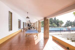 a living room filled with furniture and a pool at Albergue Inturjoven Marbella in Marbella