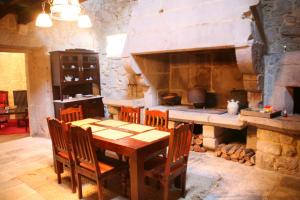 a dining room with a table and a large oven at Pazo Da Escola in A Moreira