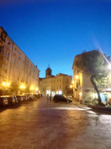 a city street at night with a tree and buildings at SatorRotas Apartment in Vasto