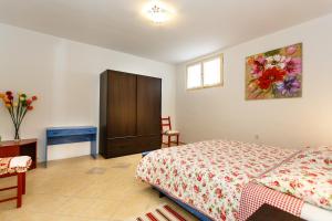 a bedroom with a bed and a cabinet in it at Apartments Danica in Vrbnik