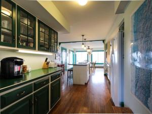 cocina con armarios verdes y comedor en Home Away from Home en North Hero