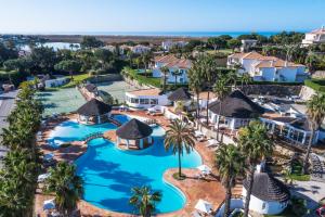 an aerial view of a resort with a pool and palm trees at Encosta Do Lago Resort Club in Quinta do Lago