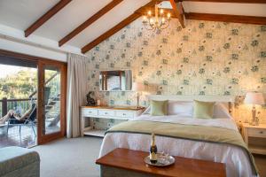 A bed or beds in a room at The Fernery Lodge & Spa