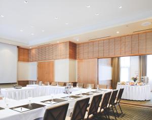 a large room with tables and chairs in it at Pan Pacific Whistler Village Centre in Whistler +20 photos