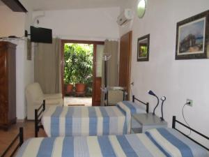 a bedroom with two beds and a television in it at B&B da NINA in Sabbioneta