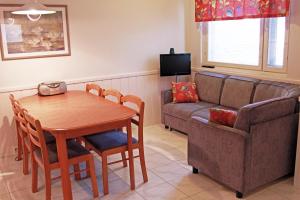 a living room with a table and a couch at Polar Star Moonlight Apartments in Levi