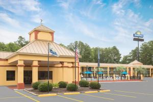 a large building with a sign in a parking lot at Days Inn by Wyndham Orangeburg South in Orangeburg