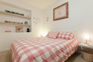フィレンツェにあるAgnolo garden & fresh marketのベッドルーム1室(赤と白のチェック毛布付きのベッド1台付)
