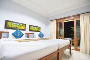 Postel nebo postele na pokoji v ubytování Artja Inn Ubud