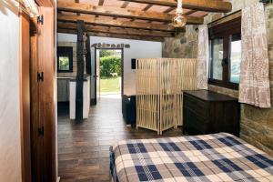 a bedroom with a bed and a dresser and a door at La Vega del Prado in Tarifa