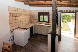 a kitchen with a counter and a sink and a window at La Vega del Prado in Tarifa