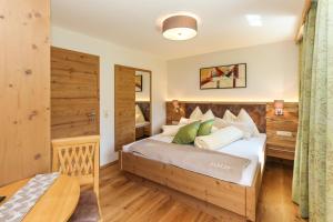 a bedroom with a large bed in a room at Ferienhof Pfefferbauer in Saalbach Hinterglemm