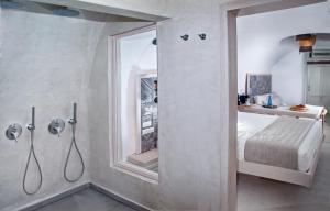 
a bathroom with a sink, toilet, and shower at Aperto Suites - Adults Only in Fira
