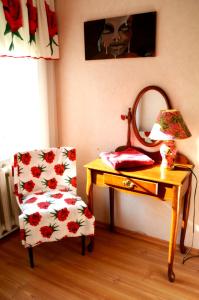 a room with a table with a chair and a mirror at Roosi Holiday Home in Rannaküla