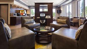 a living room with couches and chairs and a table at Best Western Plus North Houston Inn & Suites in Houston