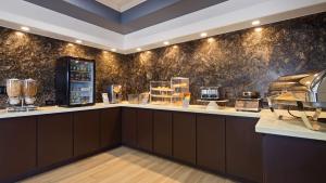 a coffee shop with a counter and a wall at Best Western Plus North Houston Inn & Suites in Houston