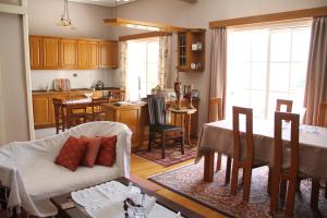 uma cozinha e sala de estar com um sofá e uma mesa em Family house em Kalamata