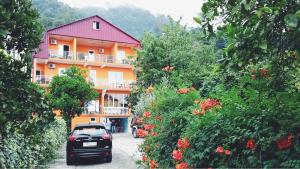 a car parked in front of a building at Kvariati - Guest House in Kvariati