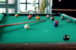a pool table with balls and cues on it at STF Sigtuna Vandrarhem in Sigtuna