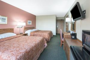 a hotel room with two beds and a flat screen tv at Super 8 by Wyndham Perham in Perham