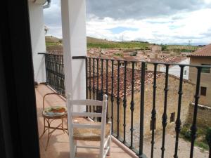 a white chair sitting on a balcony with a view at Casa Jean Pineau in Elciego