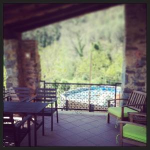 a balcony with a table and chairs and a view at Farmhouse B&B Castagnola 64 in Ne