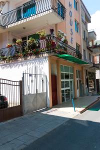 a building with balconies and flowers on the side of it at Sea House Guest House in Nesebar