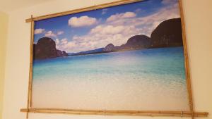 a painting of a beach on a wall at Bed Rho Fiera - Milano Galeazzi in Rho