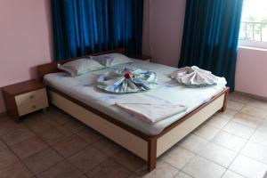 a bed with a plate on it in a bedroom at Sea House Guest House in Nesebar