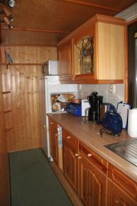 a kitchen with wooden cabinets and a counter top at Ferienhaus-Maxen in Müglitztal