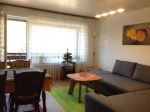 a living room with a couch and a table at Haus-Sonnenbichl-Wohnung-102 in Oberstdorf