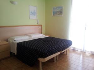 Postel nebo postele na pokoji v ubytování Hotel Delle Mimose