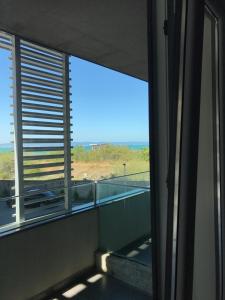 a room with a window with a view of the ocean at Botabara Del Mar Apartments in Pomorie