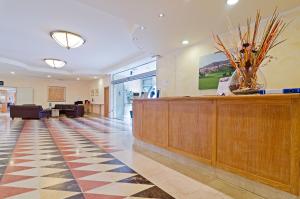 a lobby with a reception desk and a waiting room at Castellaro Golf Resort in Castellaro