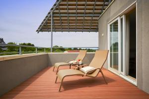 a balcony with two chairs and a table at ibis Styles Guéret in Guéret