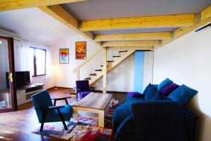 a living room with a couch and a table and stairs at Apartment Olive Groove in Malinska